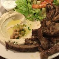 Gyro Plate · Spiced lamb and beef with tzatziki sauce. Served with salad, hummus, and pita bread.