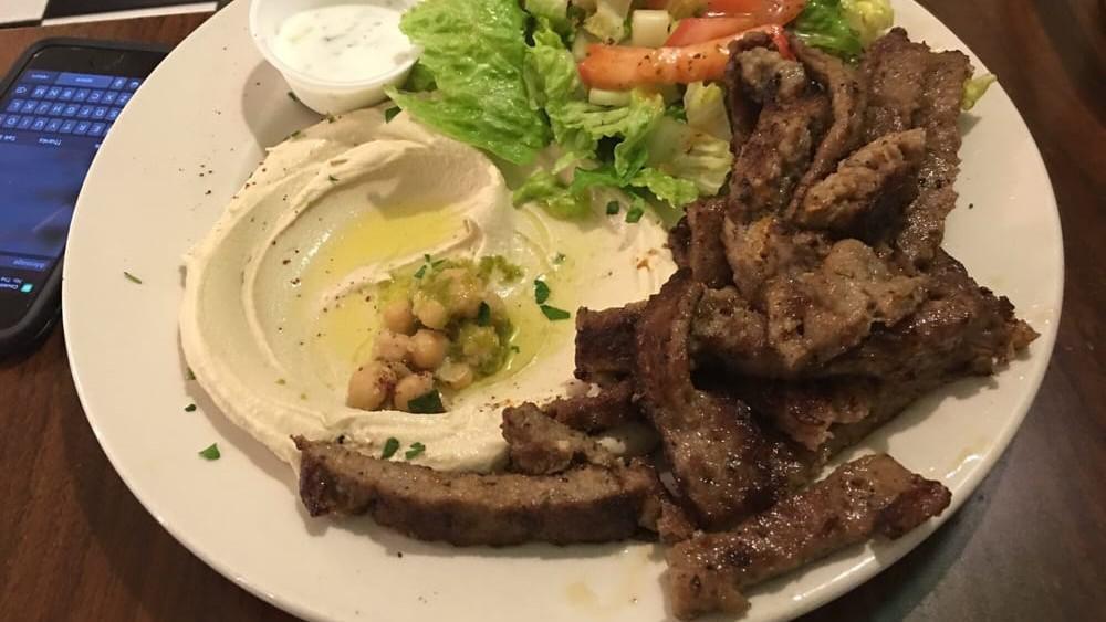 Gyro Plate · Spiced lamb and beef with tzatziki sauce. Served with salad, hummus, and pita bread.