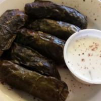 Meat Grape Leaves Plate · Stuffed with rice, ground beef, and parsley. Served with salad, hummus, and pita bread.