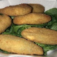 Jalapeño Poppers · Spicy jalapeño peppers stuffed with Cheddar cheese, dipped in a golden batter, and paired wi...