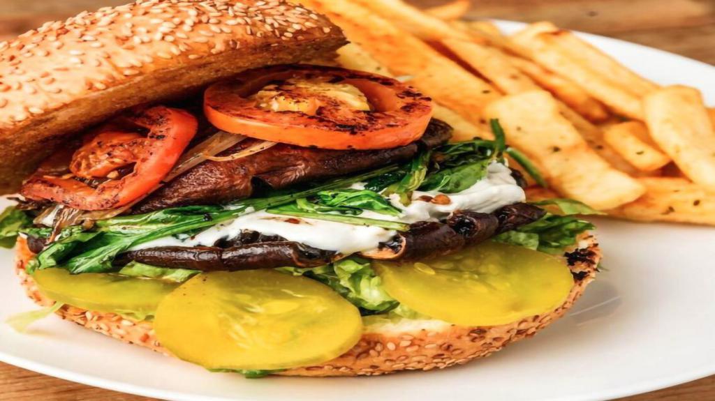 Portabella Burger · Vegetarian. A vegetarian delight, fresh black beans, roasted corn, and tomato patty dressed with lettuce, tomatoes, sprouts, avocado, onions, and roasted red pepper mayonnaise. Served on a honey wheat bun and French bread with seasoned fries.