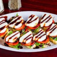 Caprese · Fresh mozzarella, tomatoes, basil and balsamic reduction on toast points.