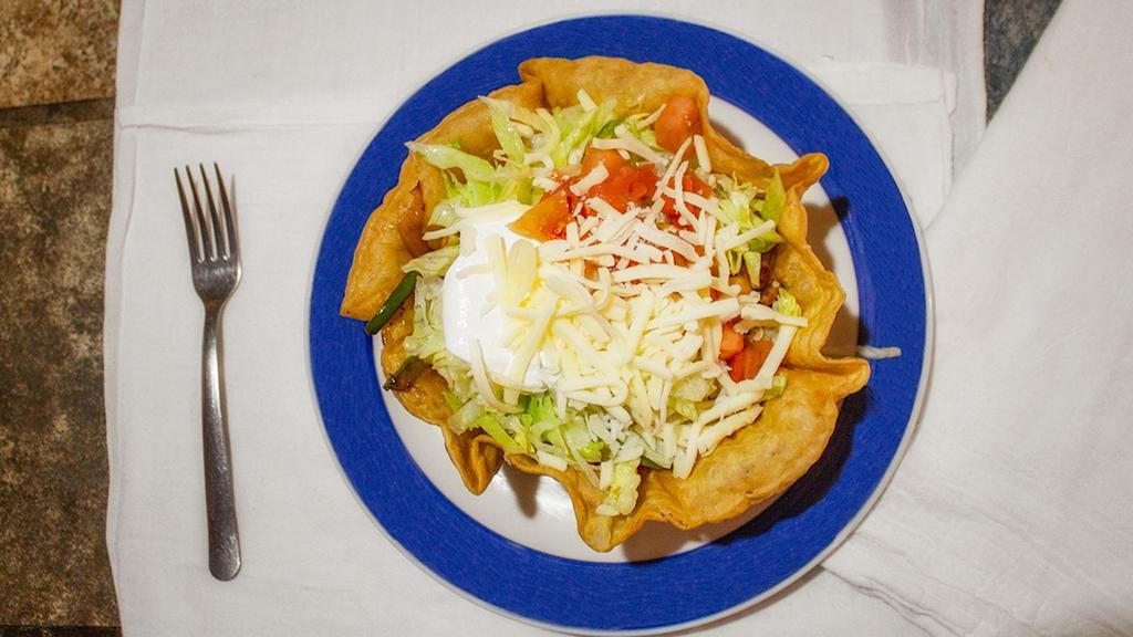Taco Salad · Shredded chicken or ground beef, lettuce, tomatoes, rice, sour cream, and shredded cheese.