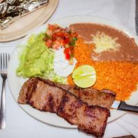 Carne Asada · Thin slices of grilled steak. Served with Mexican rice, beans, lettuce, guacamole, sour crea...