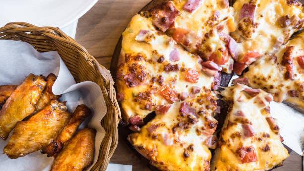 Small Chicken Ranch Pizza And Wings · Grilled chicken with crispy red onions and green peppers with a sour hint of tomato, all on a ranch-base cheese pizza. Comes with 6 wings of your flavor choice.