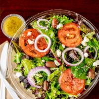 Chic Greek Loaded Salad · A large salad of organic spring mix topped with kalamata oilves, tomato, red onion, feta, an...