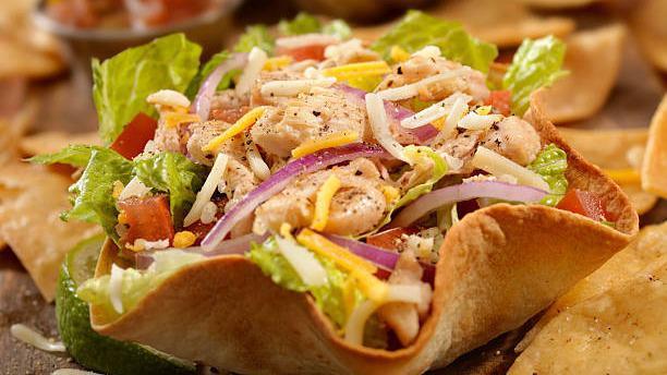 Taco Salad · Crispy flour tortilla filled with beef or chicken, cheese, lettuce, tomatoes, guacamole and sour cream.