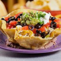 Margarita Taco Salad · Crispy flour tortilla filled with lettuce, cheese, guacamole, sour cream, and tomatoes, topp...