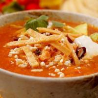Tortilla Soup · A zesty chicken broth filled with tender chicken and tortilla strips. Topped with grated che...