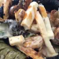 Molcajete · Chicken, steak, shrimp strips perfectly cooked with cactus, chorizo, slice of cheese, baby o...
