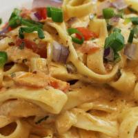 Fettuccine Alfredo · A generous portion of pasta with creamy homemade alfredo sauce.