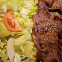 Carne Asada · Tender roast beef with refried beans, Spanish rice, guacamole salad, flour tortillas and gre...