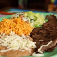 Carne Asada · Roasted steak served with rice, beans and salad.