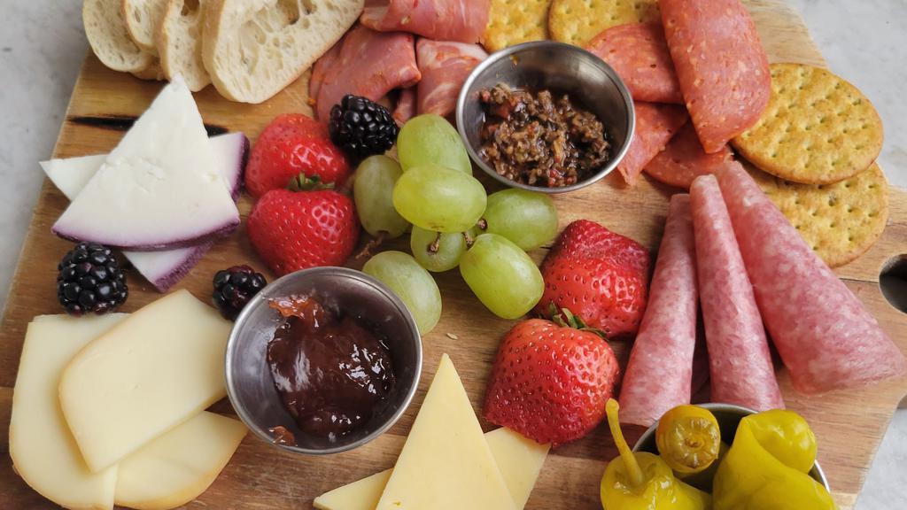 Charcuterie Board · Rotating selection of cheese and meats, pepperoncini, grapes, olive tapenade, seasonal jam, imported mustard, toast point, crackers.