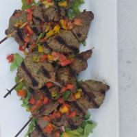 Bocados De Carne · Four steak skewers marinated with chimichurri, served with homemade pico and arugula