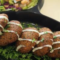 Falafel · Crispy deep-fried ground chickpea, fava beans and spices served with tahini sauce.