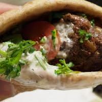 Beef Kabab Sandwich · Pita wrap with grilled beef Kabob, hummus, onion, and pickle.