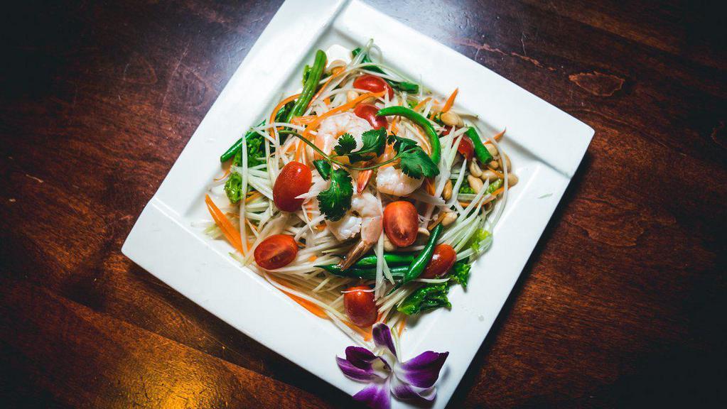 Green Papaya Salad · Hot and spicy. With roasted peanut and chili peppers dressed in lime juice and palm sugar