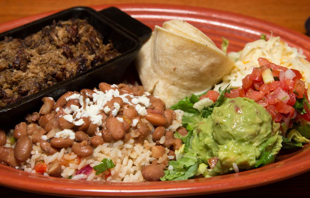 Mexican Barbacoa · Nuestro favorito! Slow-cooked and shredded pork. Served with Mexican rice, charro beans, guacamole, pico de gallo, shredded Mexican cheeses and lettuce with flour tortillas.