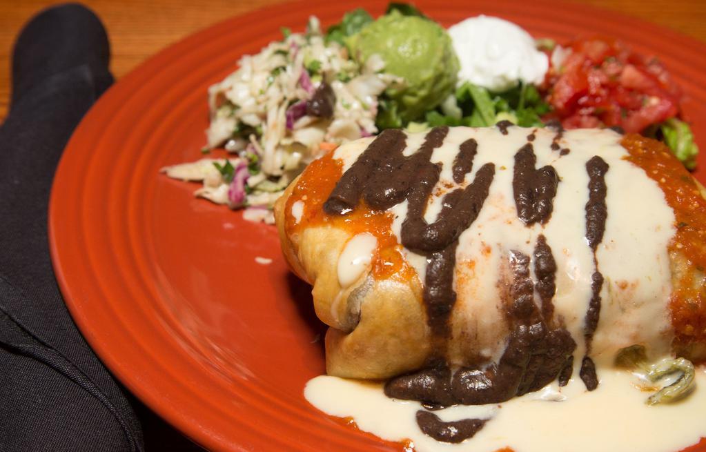 Chimichanga · Crispy burrito filled with Ground Beef, Chicken or Steak, pico de gallo black beans, rice, and cheese. Topped with Ranchero and queso sauce. Served with guacamole, sour cream, pico de gallo, lettuce and tortilla slaw.