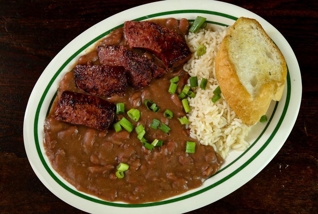 Red Beans And Rice · Another New Orleans original. Red beans cooked up with sausage & ham, local spices served over rice with smoked sausage from the grill. Add Crispy fried chicken for an additional charge.