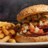 Muffaletta · A Big local favorite! Ham, salami & pastrami piled high on a seeded French bun topped with m...