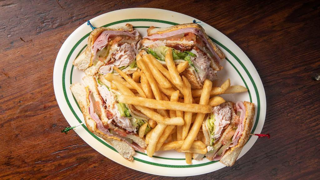 Café Maspero Club · Traditional club served cold. Dressed on white or wheat bread, piled high  with smoked turkey, ham, bacon, both American & Swiss cheese, lettuce, tomato, pickles & mayo