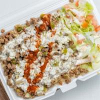 Lamb Over Rice · Grilled lamb over brown rice and salad topped with homemade taziki sauce (white sauce). whit...