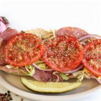 Italian Sub · Salami, pastrami, prvolone, lettuce, tomatoes, red onions, oil, vinegar, and oregano on a ho...