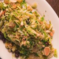 Shaved & Braised Brussels · With Marcona
almonds and raisins.
