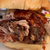 The Big Porker · Slow Smoked Pulled Pork Sandwich. Served w/Housemade BBQ Sauce, Pickles & Onions. Served on ...