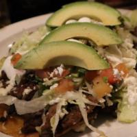 Tacos De Pastor · Three tacos filled with marinated pork, served with rice, beans, lettuce, sour cream and pic...