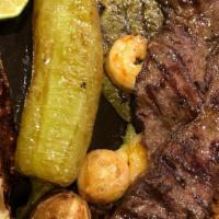 Steak Poblano · Rib-eye steak with onions, tomatoes, mushrooms and poblano peppers covered with Monterey Jac...