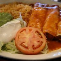 Chicken Flautas · Two fried flour tortillas stuffed with chicken. Served with rice, beans, lettuce, guacamole ...