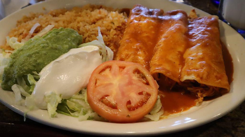 Chicken Flautas · Two fried flour tortillas stuffed with chicken. Served with rice, beans, lettuce, guacamole and sour cream.