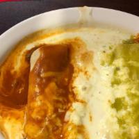 Crabmeat Enchiladas · 3 enchiladas filled with crabmeat topped with white queso. Served with rice, lettuce, tomato...