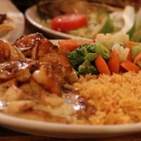 Pollo Ranchero · Grilled to perfection chicken breast topped with salsa roja and cheese dip, served with rice...