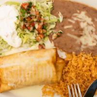 Chimichanga · Deep fried tortilla stuffed with beef or chicken served with rice, beans, pico de gallo, let...