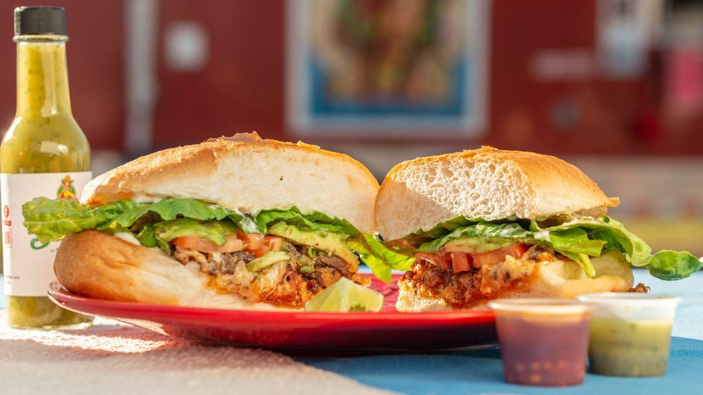 Torta · Bread, mayo, meat of choice, avocado, lettuce, tomato, onions (raw or grilled). Add queso or cheese for an additional charge. / pan, carne de elección, aguacate, lechuga, tomate, cebolla (cruda o asada).