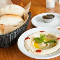 Hummus · Purée of chickpeas whipped with tahini, garlic and lemon juice, finished with extra virgin o...
