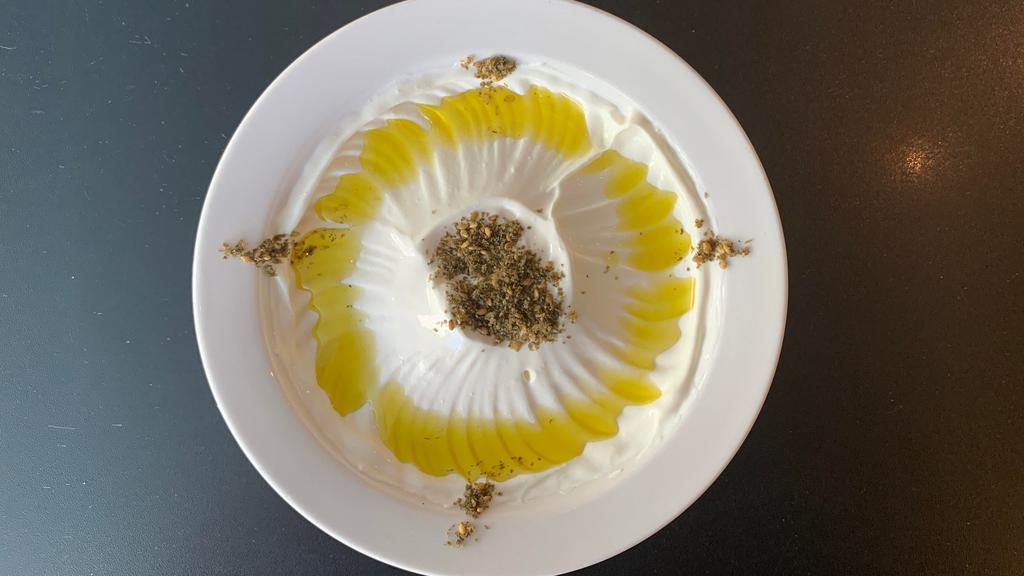 Labneh · Lebanese strained yogurt drizzled with extra virgin olive oil and za’atar.