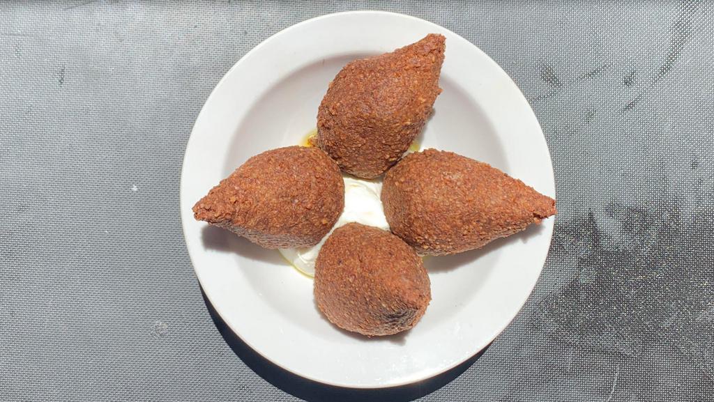 Kibbee Mikli · Fried dumplings of ground beef and lamb mixed with cracked wheat and onion, then stuffed with sautéed minced beef and lamb, onion, pine nuts and spices. Served with house-made labneh and Shaheen extra virgin olive oil.