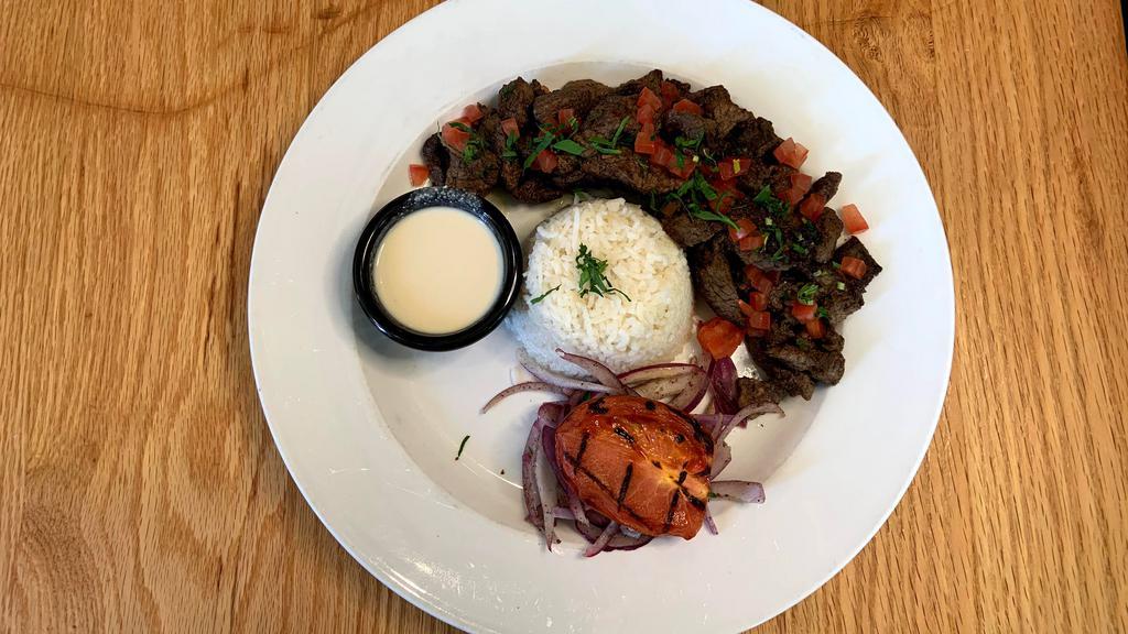 Beef & Lamb Shawarma · Thinly sliced marinated tender beef and lamb served with basmati rice, grilled tomato, sumac onion and tahini sauce.