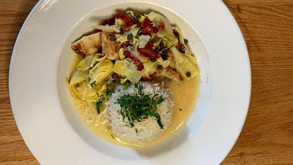 Chicken Artichoke · Lightly breaded chicken breast, sliced and served over basmati rice and topped with sautéed artichoke hearts, sun-dried tomatoes and capers, finished with lemon butter.