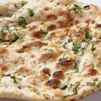Garlic Naan · Unleavened bread with garlic on top and then baked in the tandoor.
