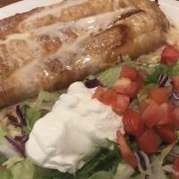 Mucho Burrito · Large tortilla filled with shredded chicken or beef, deep fried with rice and beans, covered...