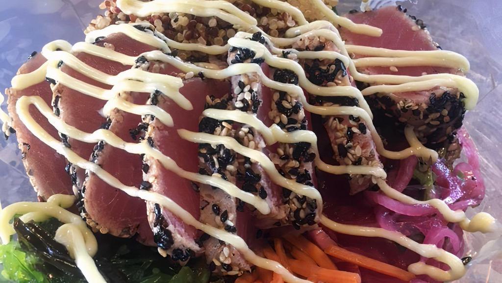 Ahi Power Bowl · Seared sesame encrusted ahi tuna, seaweed salad, pickled red onions, pickled carrots, cucumbers  and quinoa over mixed greens topped with sesame wasabi aioli.