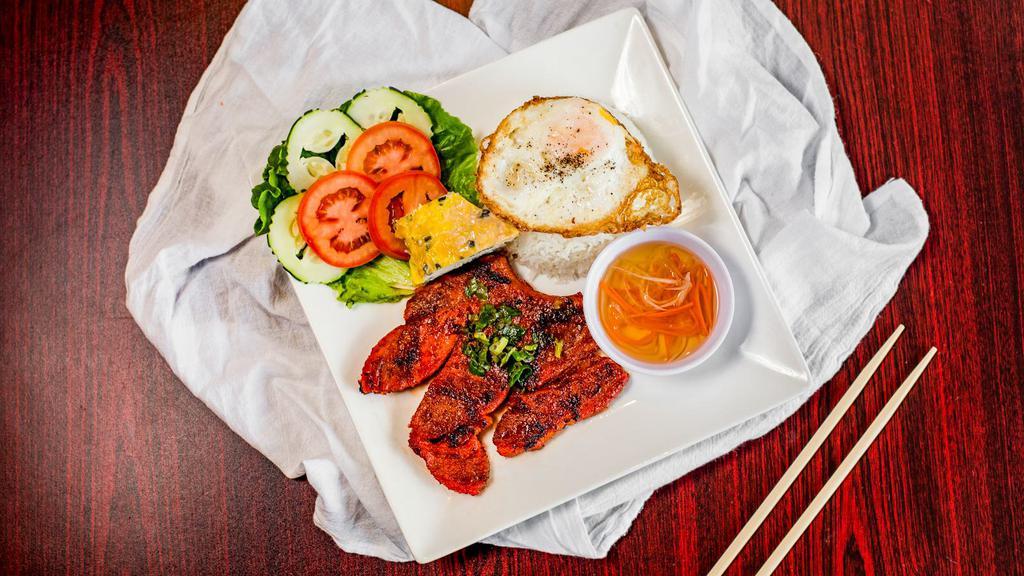 Rice Plate · Served with a marinated pork chop, fried egg, shredded pork, egg omelet, and house-made fish sauce.