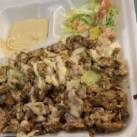 Chicken Shawarma Plate · Marinated grilled chicken over a bed of yellow rice drizzled with tahini sauce, with side sa...