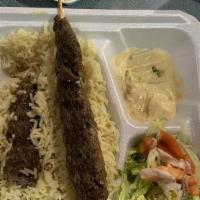 Beef Shish Kabab Plate · Two skewers of seasoned beef over yellow rice drizzled with tahini served with a side salad ...
